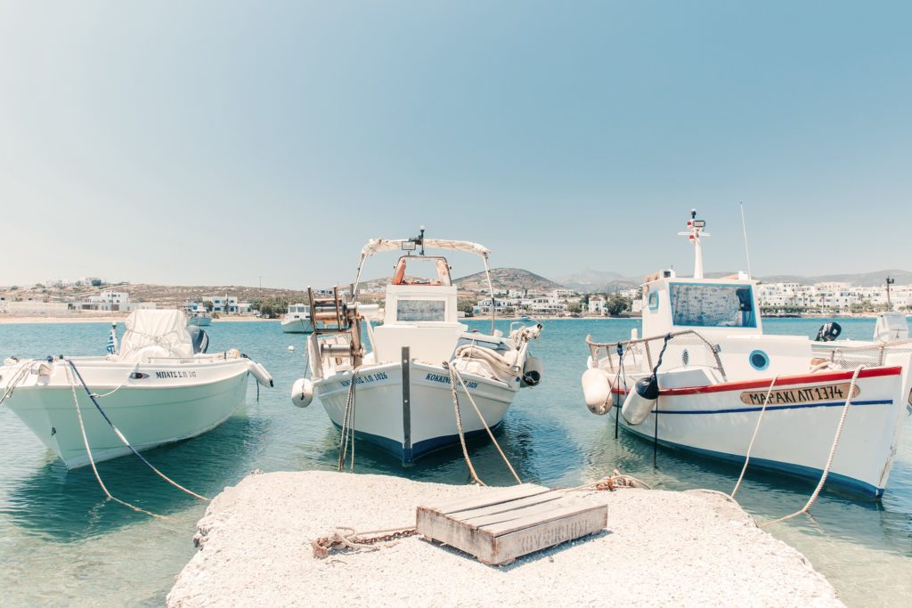 Painted wooden fishing boats tied up in the harbour at Naousa