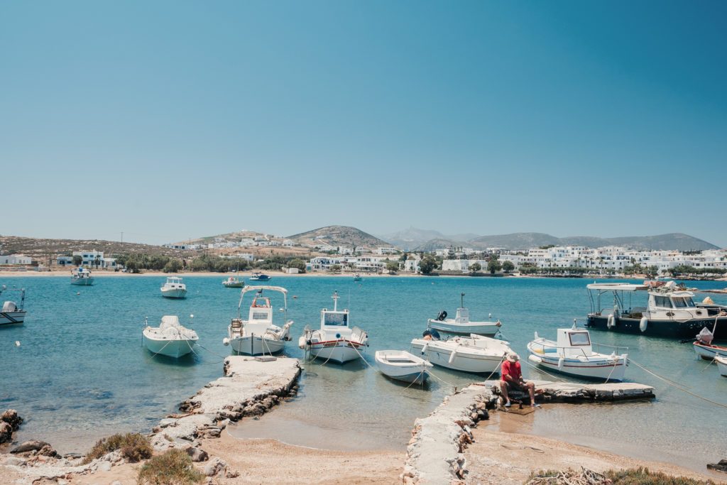 Fishing boats moored along the shore with Naousa behind them