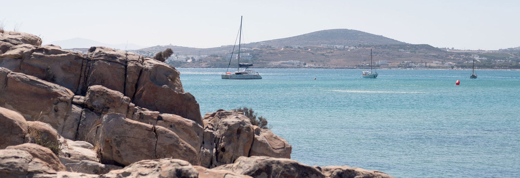 The granite rock formations and clear shallow water at Kolymbithres beach