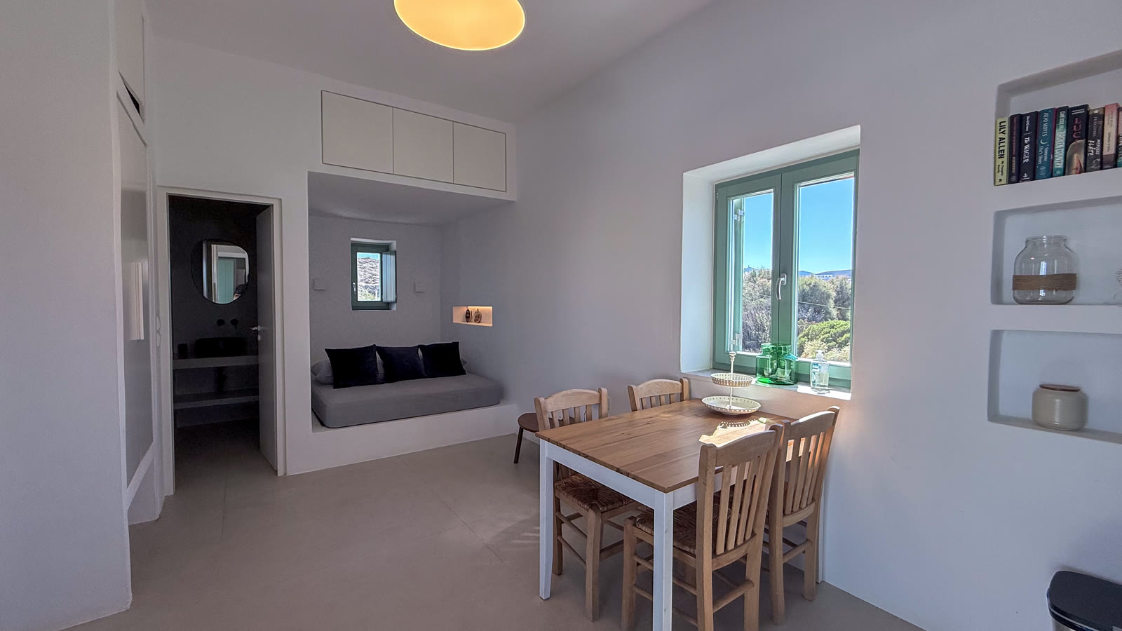 The bright open-plan living and dining room with its built-in sofa