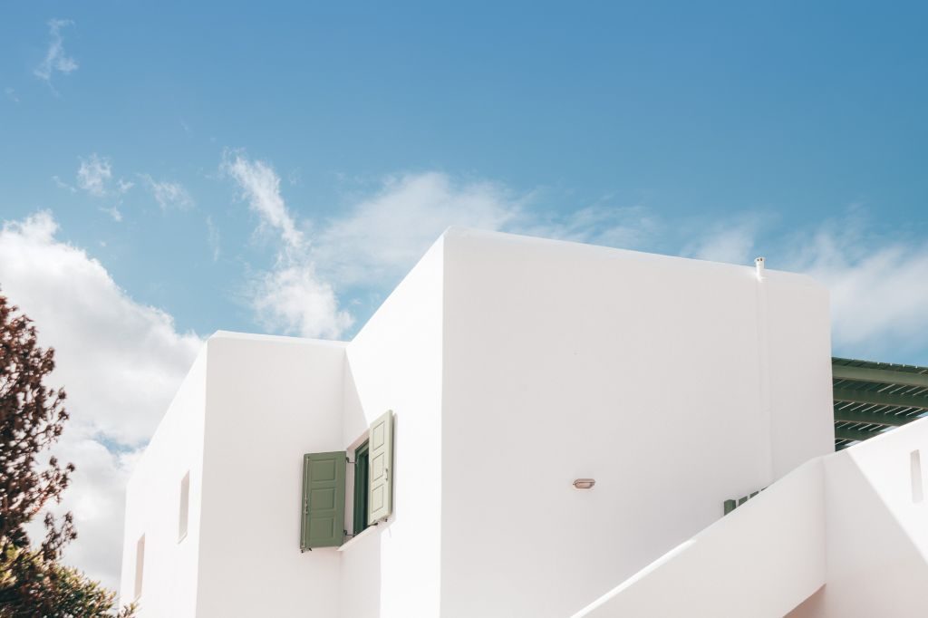 The whitewashed Cycladic exterior against a blue sky