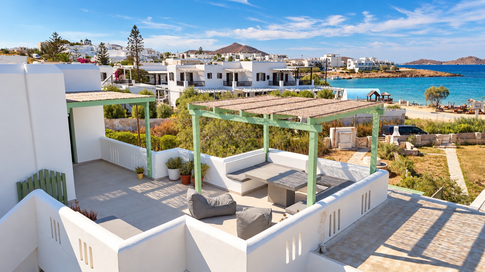 An elevated view across the bright terrace towards Naousa and the bay